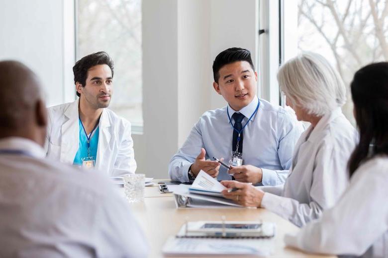 students and doctors talking at a table